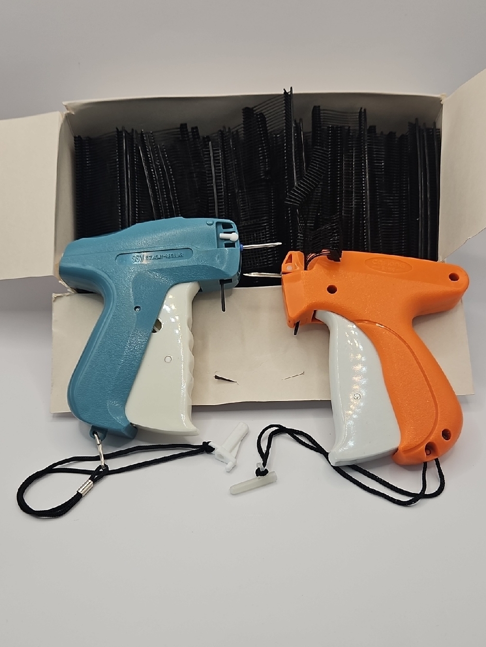 Blue and Orange Tagging Guns with Black Fasteners & Garment Tags